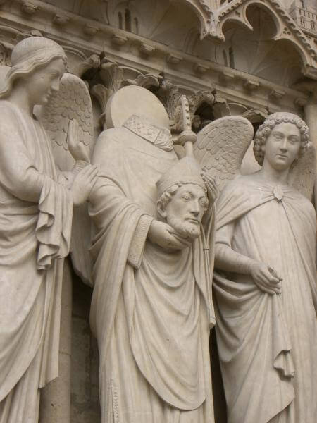 Statue of Saint Denis (middle) at Notre Dame, Paris